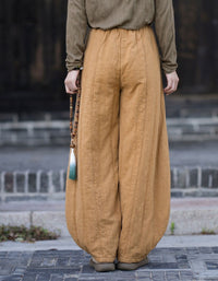 Gathered ankle cuffs on women's yellow balloon trousers with a relaxed fit