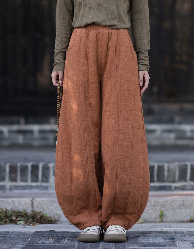 Women's loose fit orange harem pants with elastic waistband and gathered ankle cuffs
