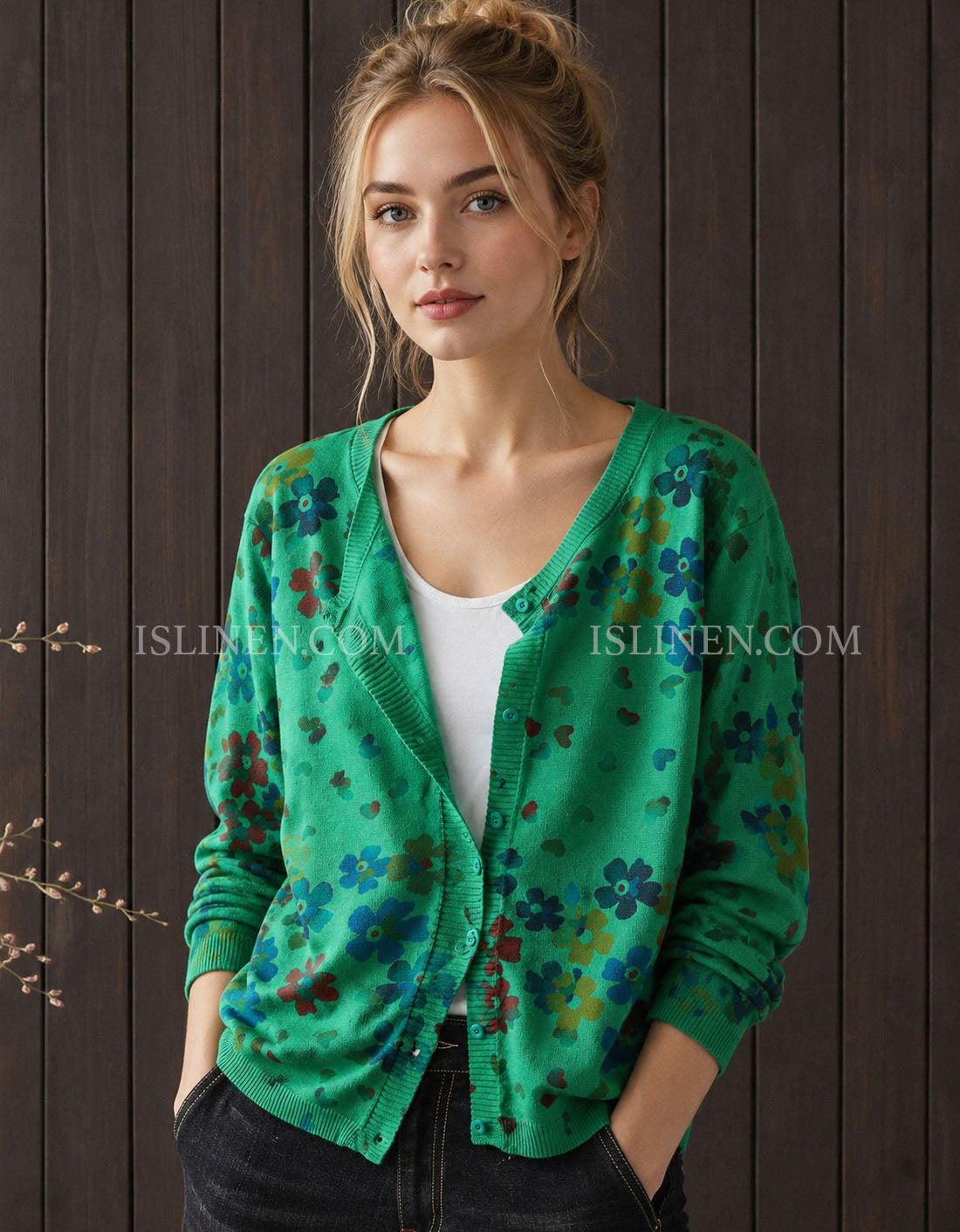 Women's green floral cardigan styled over a white top with jeans