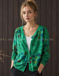 Women's green floral cardigan styled over a white top with jeans