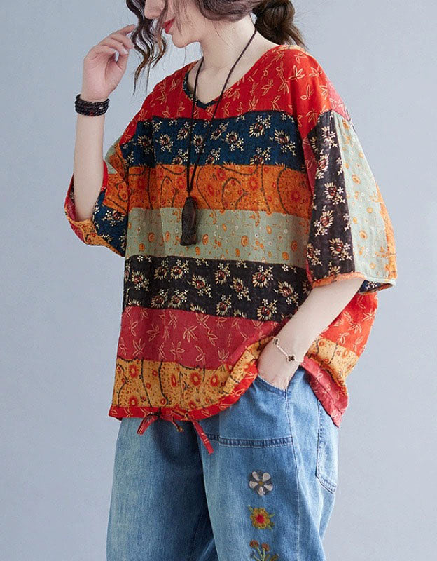 Side view of women’s boho floral top and embroidered denim pants, showcasing the relaxed fit