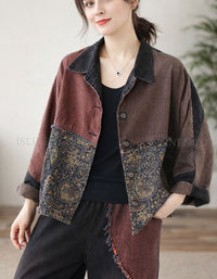 Woman wearing a brown jacket with patterned patches indoors